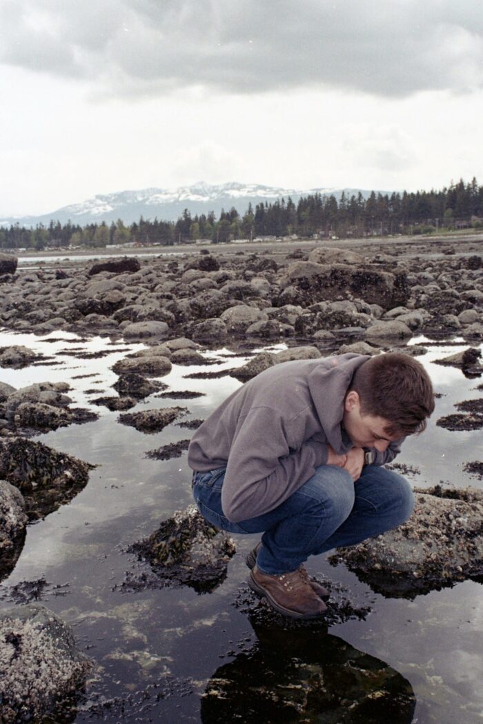 Christiansen examines tide pools in Campbell River, B.C. 