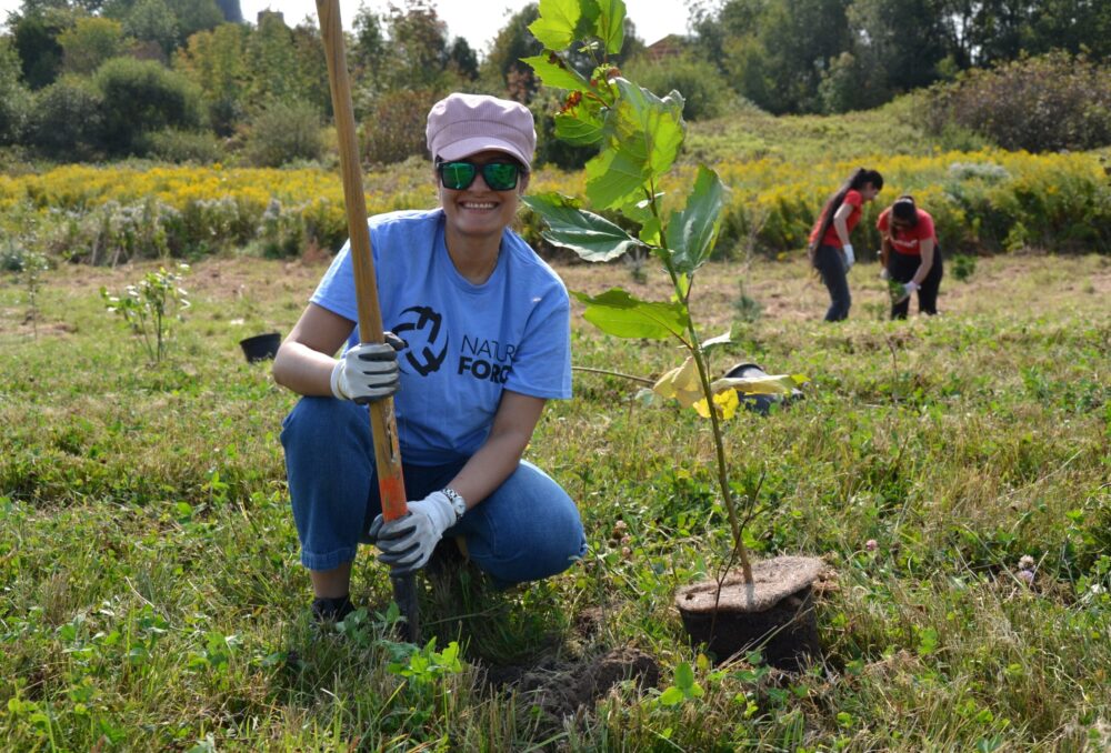 Nature Force participant planting one of many trees at the event.