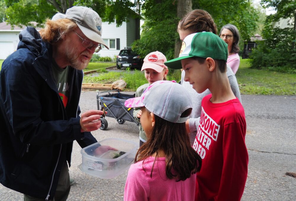 Dave Seburn, biologist and turtle specialist for the Canadian Wildlife Federation, guiding local community members on the release of turtle hatchlings.