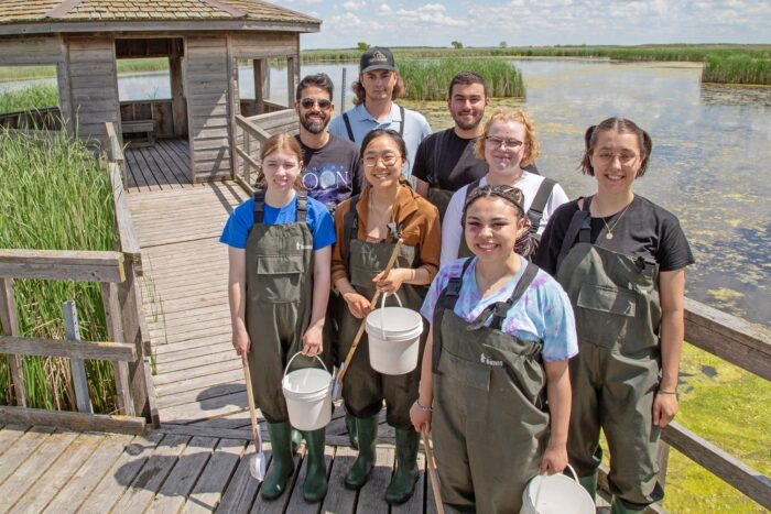 Youth Advisory Council members standing at a wetland