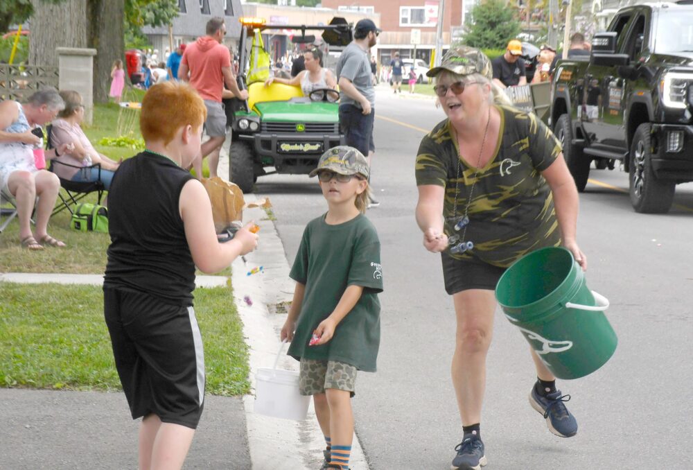 Darcy McWilliam, the energetic treasurer for the Long Point Ladies chapter, hands out treats at the 2024  Bayfest parade.