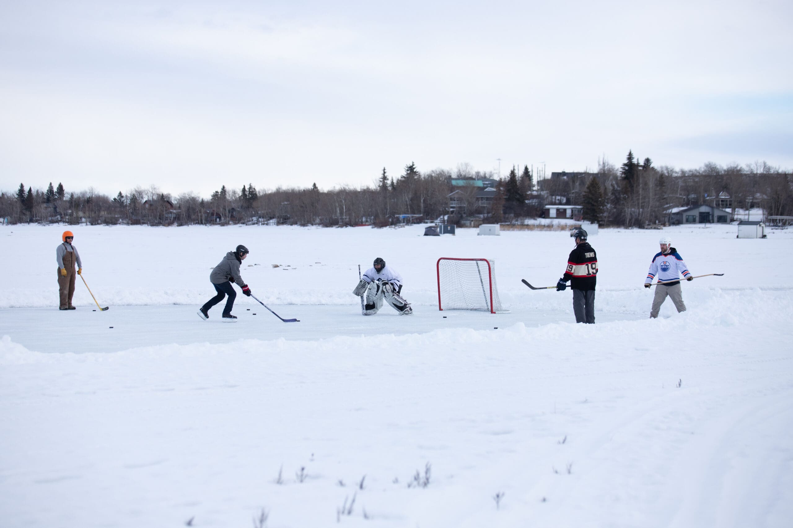 Group of people playing pond hockey