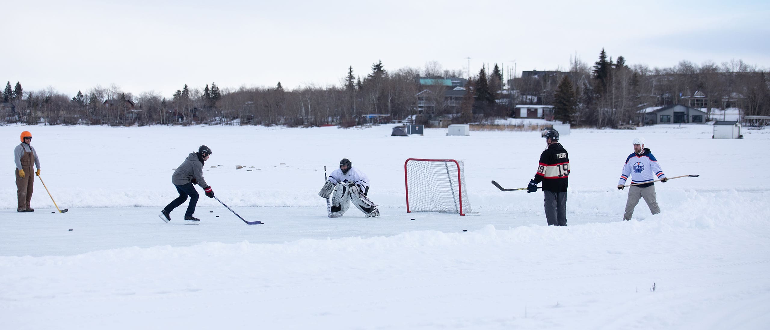 Group of people playing pond hockey